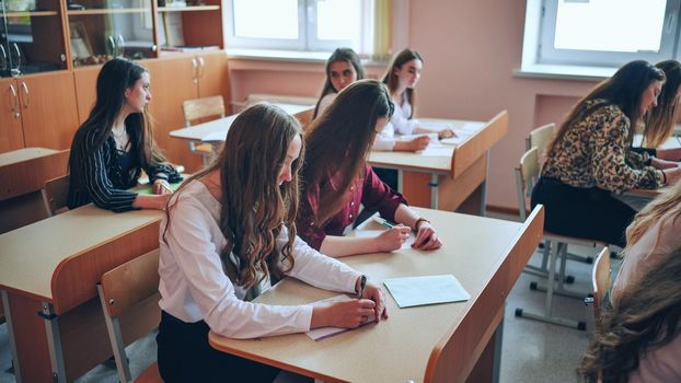 Pupils of the 11th grade in the class at the desks during the lesson. Russian school