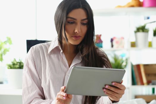 Portrait of concentrated lady look in tablet screen, work from home, remotely solve working task. Serious woman hold device, check mail. Freelancer concept