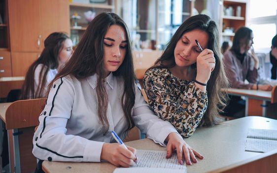 Pupils of the 11th grade in the class at the desks during the lesson. Russian school