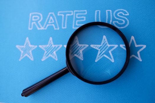 Lens lying on five stars of assessment of quality of service blue background. Quality indicator concept