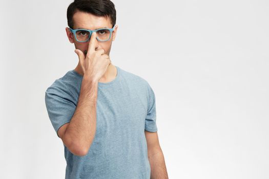 handsome man in blue t-shirt glasses gesture hands smile emotions cropped view. High quality photo