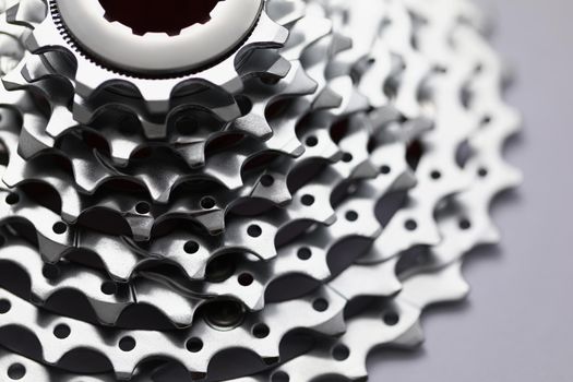 Close-up of bicycle roller chain that transfer power from pedals to drive, shiny silver detail. Rear cassette for mountain bike. Transport, vehicle concept