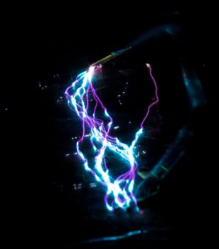 blue and purple taser electric discharge on black. High quality photo