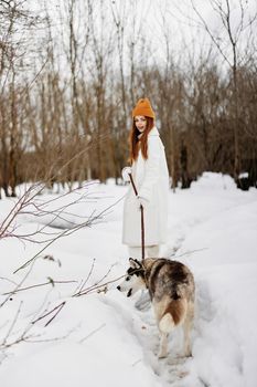 Happy young woman with a purebred dog for a walk in winter nature winter holidays. High quality photo