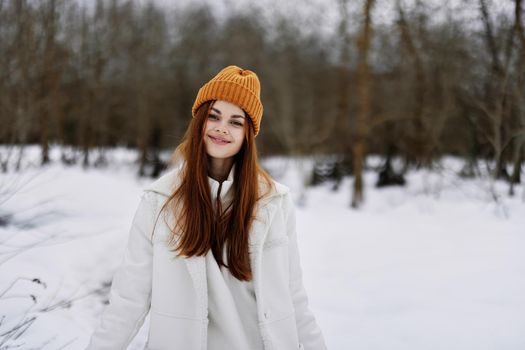 Happy young woman red hair walk in the fresh winter air winter holidays. High quality photo
