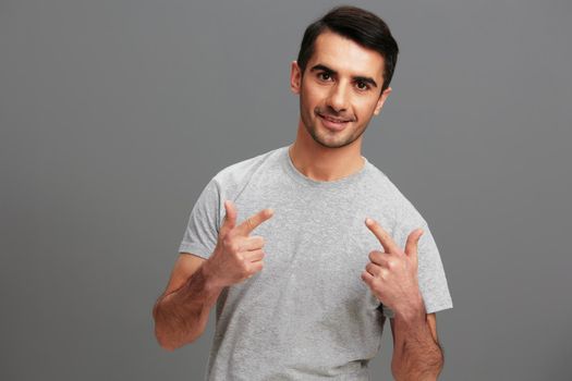 Cheerful man casual wear gray t-shirt fun fashion isolated background. High quality photo