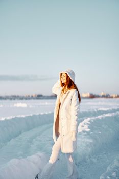 beautiful woman smile Winter mood walk white coat Fresh air. High quality photo