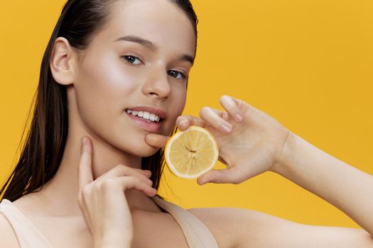 portrait woman lemon in hands posing clean skin isolated background. High quality photo