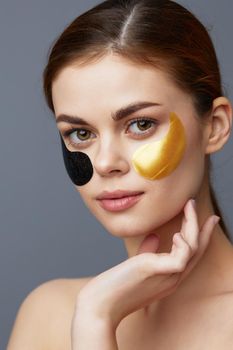 pretty woman multicolored patches rejuvenation skin care fun gray background. High quality photo