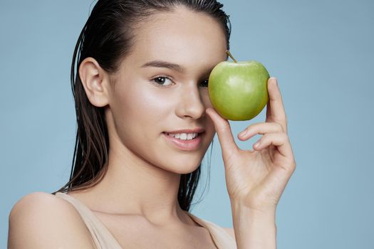 woman green apple near face health isolated background. High quality photo