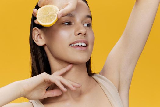 young woman with lemon near face clean skin care health close-up Lifestyle. High quality photo