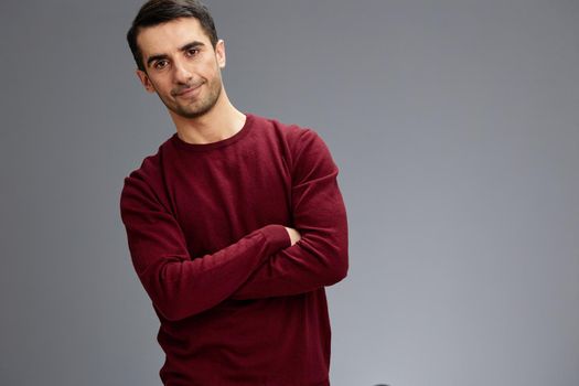 manager with folded hands posing gesture with hands red sweater elegant style. High quality photo