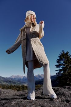 Stylish woman fashion glasses mountain top nature freedom lifestyle. High quality photo