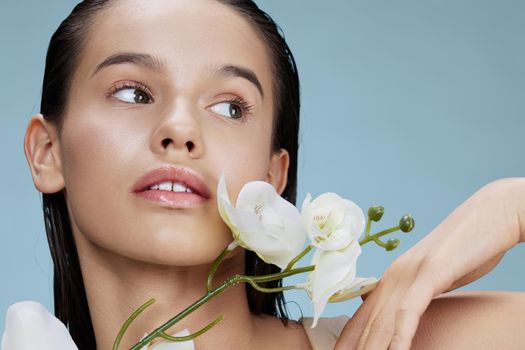 young woman orchid flower near face attractive look isolated background. High quality photo