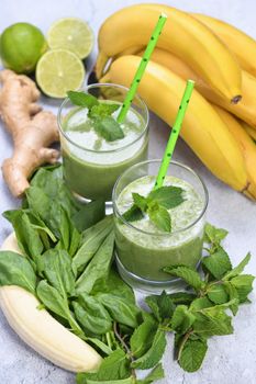 Fresh organic detox green drink smoothie with spinach, banana, lime and ginger with refreshing mint. Healthy, dietary, vegetarian food