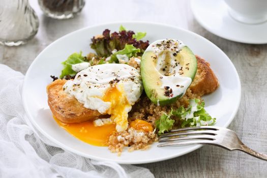 A healthy and balanced breakfast plate.
Benedict's egg spreads on a toasted toast with half an avocado, quinoa and lettuce, seasoned   spices and yogurt dressing. Enjoy the most important meal of the day
