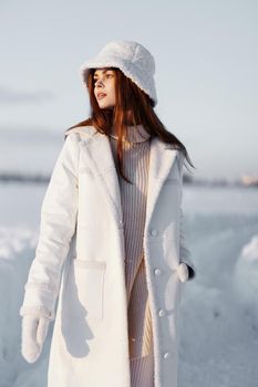 woman in a white coat in a hat winter landscape walk travel. High quality photo