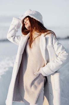 woman red hair snow field winter clothes travel. High quality photo