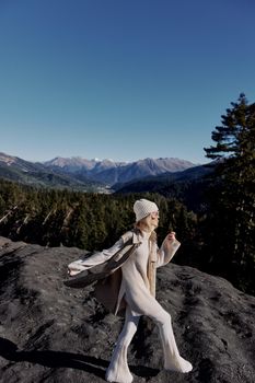 Stylish woman Cliffs mountains fashion posing nature fresh air lifestyle. High quality photo