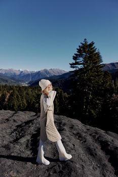 Stylish woman Cliffs mountains fashion posing nature fresh air relaxation. High quality photo