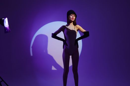 Pretty young female scene spotlight posing neon purple background unaltered. High quality photo