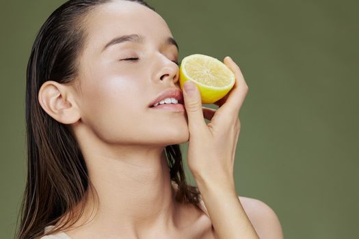 brunette with lemon near face clean skin care health isolated background. High quality photo