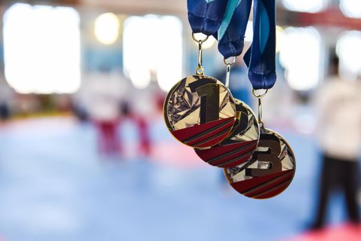 medals, gold, silver, and bronze on a blurred background with copy space.