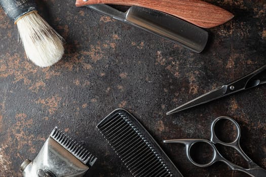 vintage barber tools dangerous razor, hairdressing scissors, old manual clipper, metal comb, shaving brush. old rusty metal background. Horizontal. top view, flat lay.