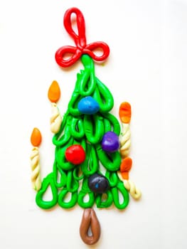 children's crafts Christmas tree with candles and balls of plasticine isolated