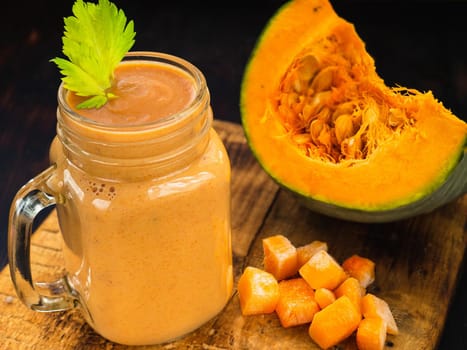 Pumpkin smoothie with celery leaves and pumpkin cubes.