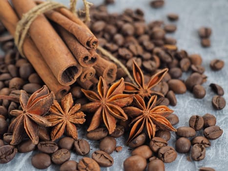 coffee cinnamon and star anise on gray background close up