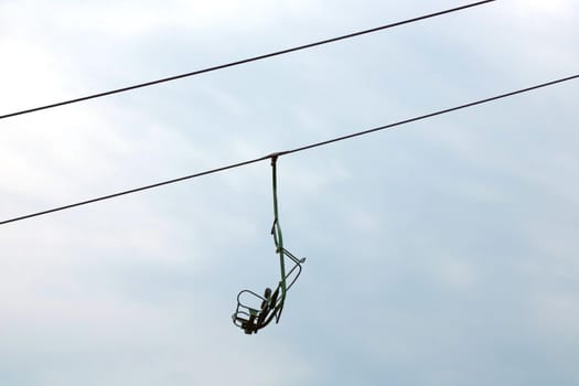 An empty lift in the mountains against a cloudy sky. Pandemic, highway closures