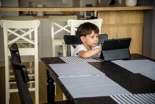 Toddler staring at tablet. Education, gadget, dependency, technology, addiction child eyesight raising children concept.