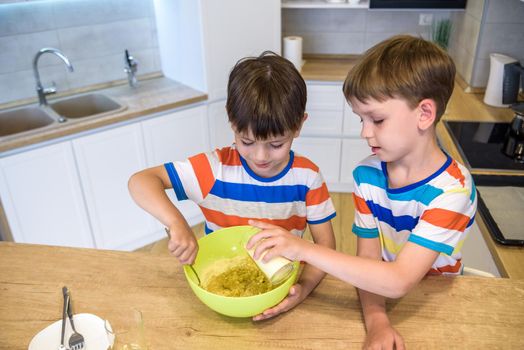 happy family funny kids are preparing the dough, bake cookies in the kitchen.