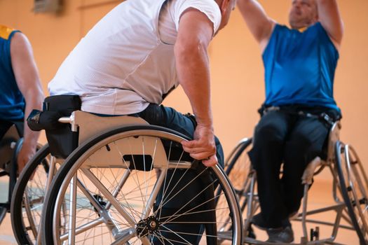 Close-up of sportsman with disability sitting in wheelchair playing basketball. High quality photo