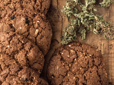 textured chocolate hemp oatmeal cookies on a wooden board. close-up.