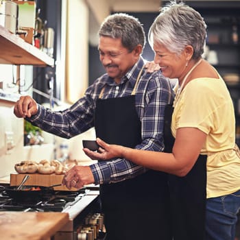 Shot of a mature couple cooking together at home