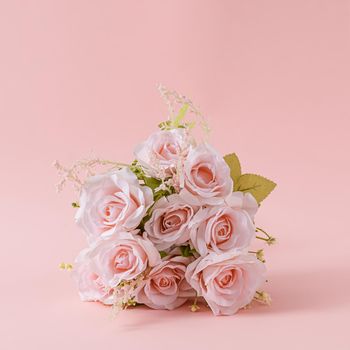 Bouquet of fresh pink roses on a square pink background as a greeting card for your sweetheart or loved one