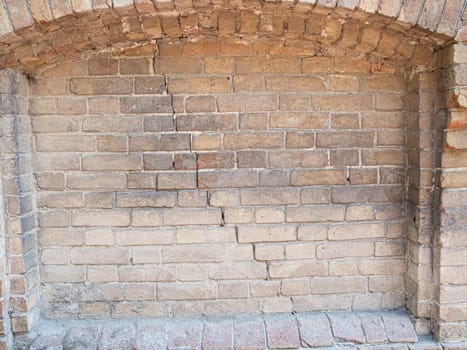 rounded Old dirty brickwork arch. Background texture. Scratches and bumps.