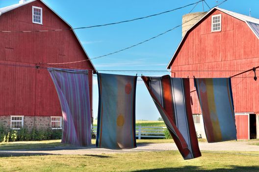 Towels Drying on a Clothesline at a Rural Farm in Ontario with Red Barns in background. High quality photo