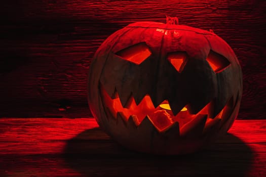 Jack O' Lantern Glowing In Fantasy Night. Halloween. On old wooden background. dramatic frame. horizontal orientation