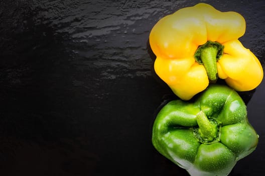 two sweet pepper on slate yin yang place on the left. top view