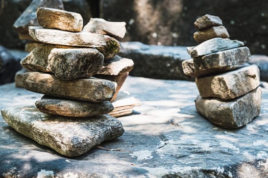 zen stone stack with balanced stones on stones in equilibrium, pile of rocks in the woods horizontal