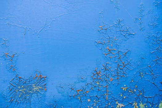 Old dirty painted wall. Several layers of peeling paint. blue. background texture. Horizontal orientation