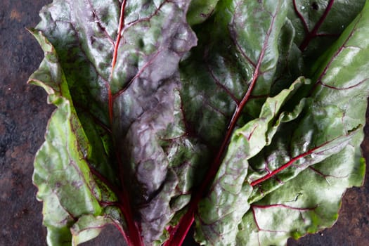 ugly food. Beets and beet leaves on a rusty beautiful metal surface. close-up. horizontal orientation. flat lay. top view.