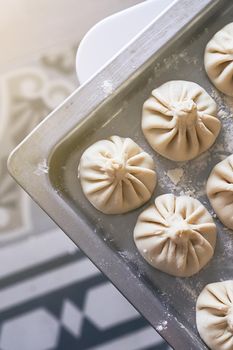Homemade khinkali Georgian dumplings on home kitchen table. National food.