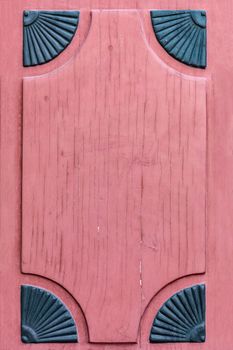 Frame part of a old wooden door painted on red.
