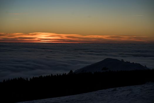 the romance of tourism and recreation, as well as the principles of a healthy lifestyle, is to watch the fantastic play of the sun's rays setting over the horizon on the highest Wasserkuppe mountain in Hesse, Germany and breathe the fresh, clean mountain air. High quality photo