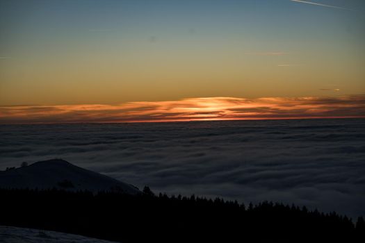 the romance of tourism and recreation, as well as the principles of a healthy lifestyle, is to watch the fantastic play of the sun's rays setting over the horizon on the highest Wasserkuppe mountain in Hesse, Germany and breathe the fresh, clean mountain air. High quality photo