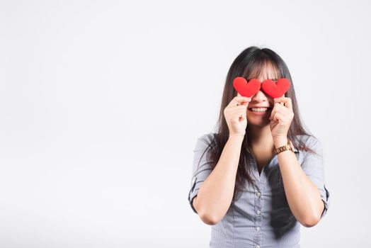 Woman standing her smile confidence cheerful cheery girl holding in hands two red heart symbol cards closing eyes isolated white background, Asian happy portrait beautiful young female valentine